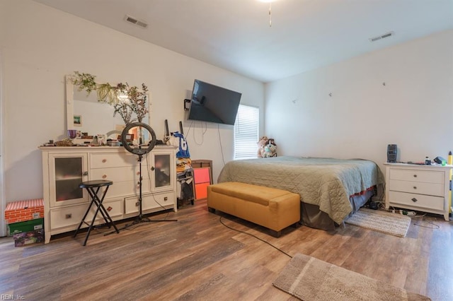 bedroom with visible vents and wood finished floors