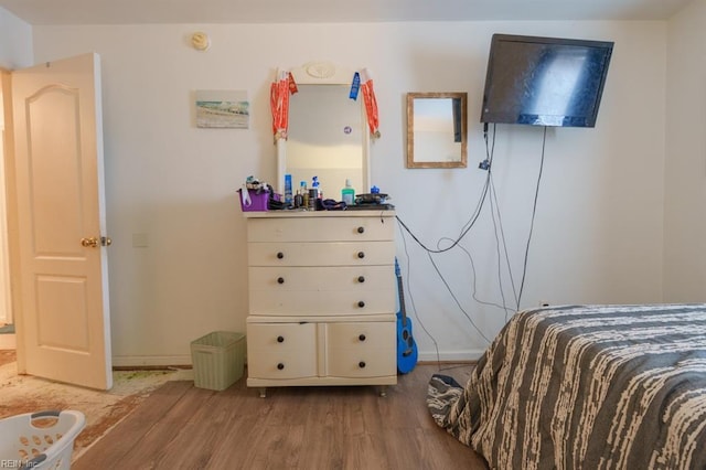 bedroom featuring baseboards and light wood finished floors