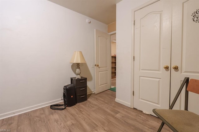 unfurnished bedroom featuring baseboards and light wood-type flooring