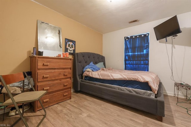 bedroom with visible vents and wood finished floors