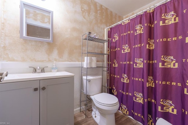 bathroom with vanity, a shower with curtain, toilet, and wood finished floors