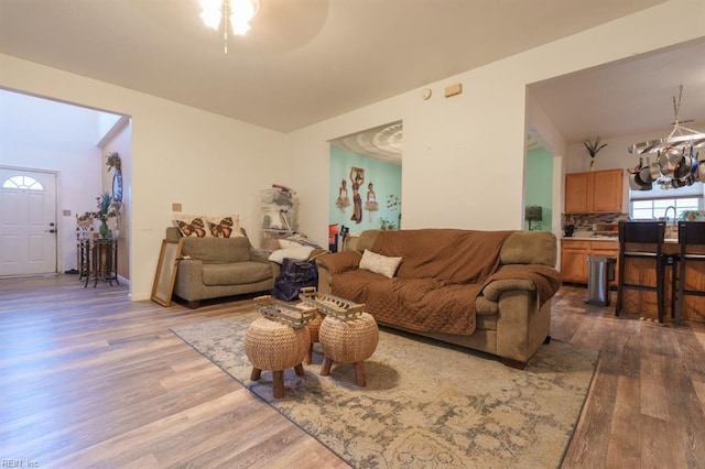 living area featuring an inviting chandelier and wood finished floors