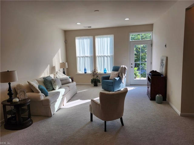 living area with visible vents, recessed lighting, baseboards, and carpet floors