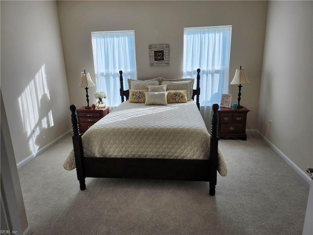 carpeted bedroom featuring baseboards