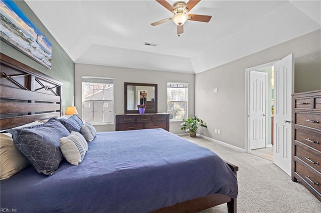 bedroom with baseboards, carpet floors, a raised ceiling, and visible vents