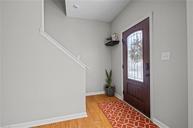 foyer entrance featuring wood finished floors and baseboards