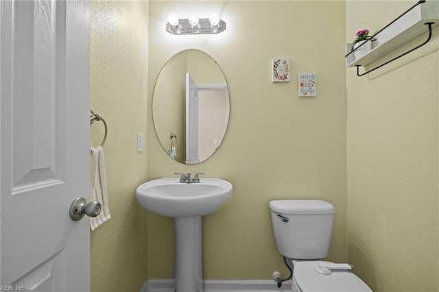 half bathroom featuring toilet