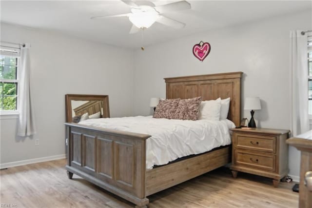 bedroom with baseboards, light wood finished floors, and ceiling fan