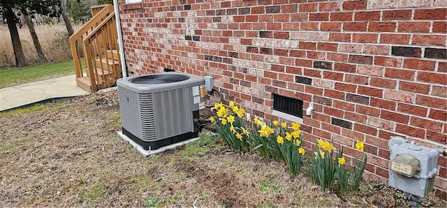 exterior details with cooling unit and brick siding