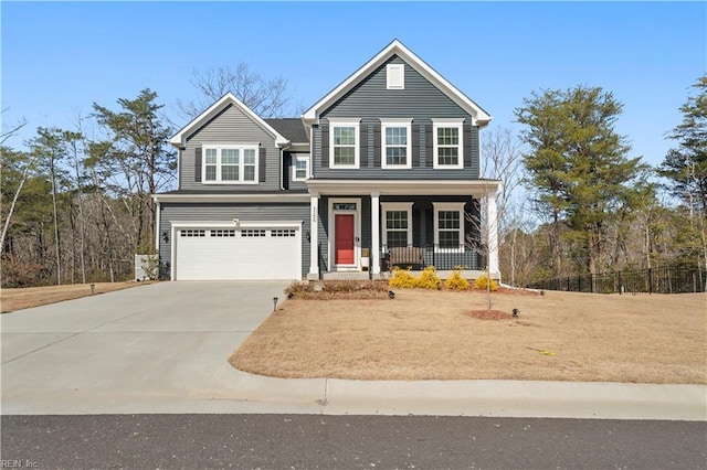 traditional-style house featuring a garage, covered porch, and concrete driveway