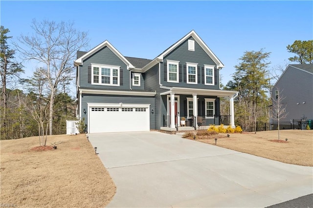 traditional home featuring a front lawn, a porch, concrete driveway, and an attached garage