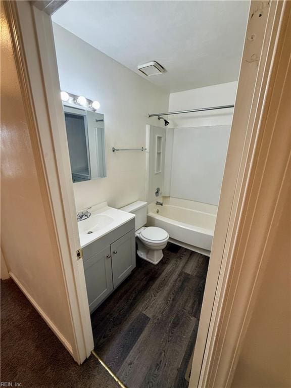 full bathroom featuring visible vents, tub / shower combination, toilet, wood finished floors, and vanity