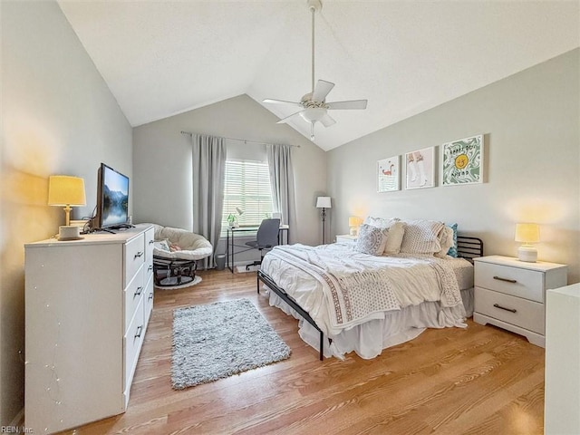 bedroom with light wood-style flooring, a ceiling fan, and vaulted ceiling