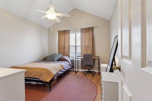 bedroom featuring vaulted ceiling, light wood-type flooring, and ceiling fan