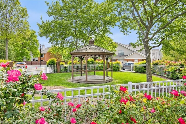 view of community featuring a gazebo, a yard, and fence private yard