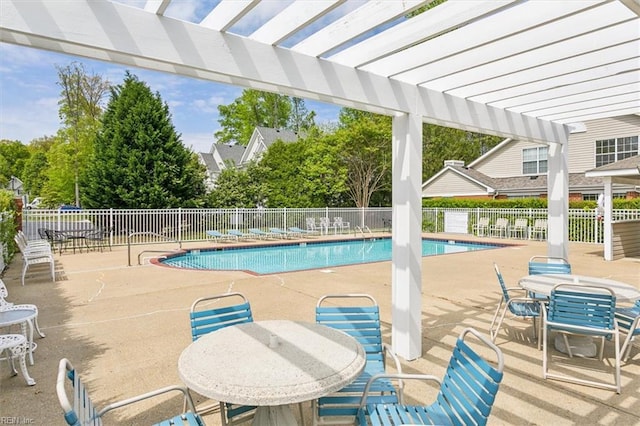 pool featuring a patio, outdoor dining area, fence, and a pergola