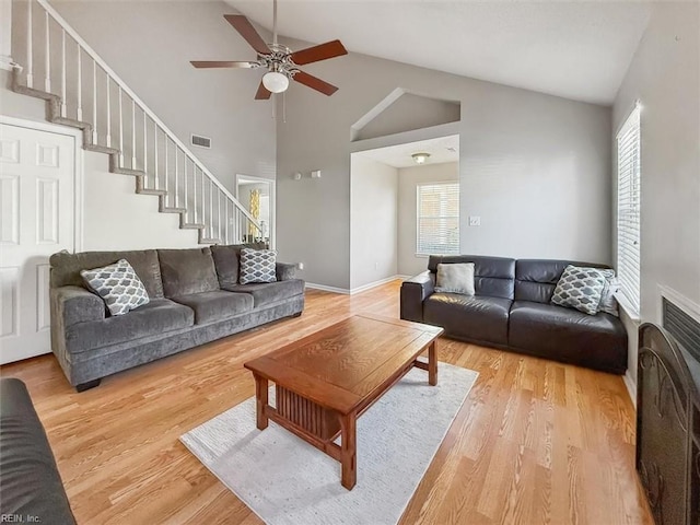 living room with visible vents, a healthy amount of sunlight, ceiling fan, and wood finished floors