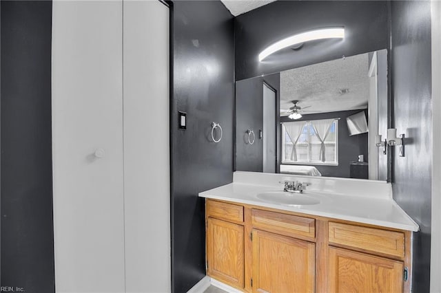 bathroom featuring a textured ceiling, vanity, and ceiling fan