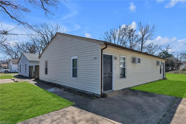 view of side of property featuring a yard