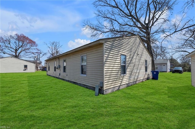 view of side of home with a lawn