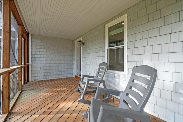 wooden terrace featuring covered porch