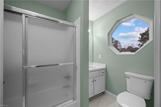 bathroom featuring a shower with door, tile patterned flooring, baseboards, toilet, and vanity