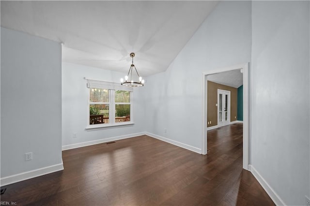 unfurnished dining area with baseboards, visible vents, dark wood finished floors, an inviting chandelier, and vaulted ceiling