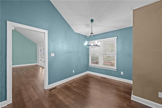 unfurnished dining area featuring visible vents, baseboards, a chandelier, vaulted ceiling, and wood finished floors