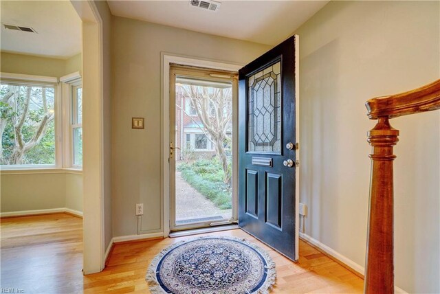 foyer with visible vents, baseboards, and light wood-style floors