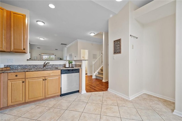 kitchen with baseboards, light stone countertops, dishwasher, light tile patterned flooring, and a sink