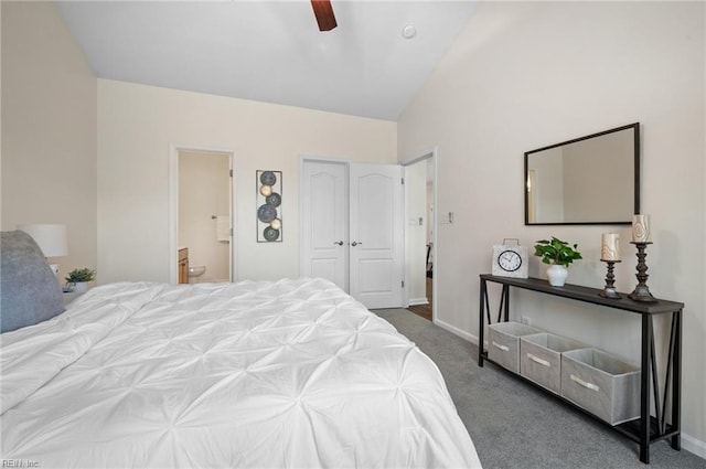 carpeted bedroom with vaulted ceiling, a ceiling fan, baseboards, and connected bathroom