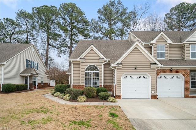 view of front of house with brick siding, driveway, a shingled roof, and a garage