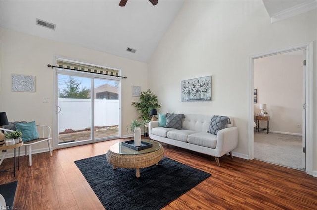 living area featuring visible vents, baseboards, ceiling fan, wood finished floors, and high vaulted ceiling