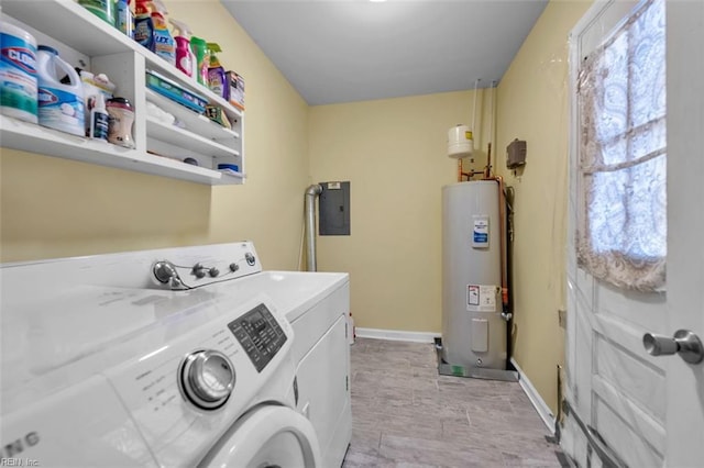 laundry area featuring electric panel, electric water heater, separate washer and dryer, baseboards, and laundry area