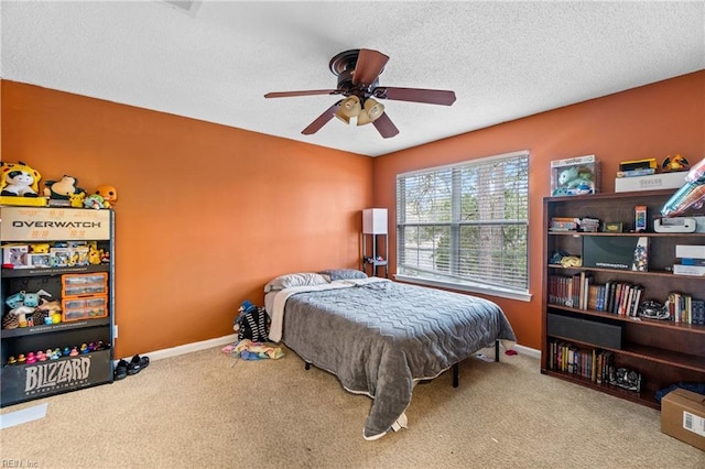 bedroom with ceiling fan, carpet, baseboards, and a textured ceiling