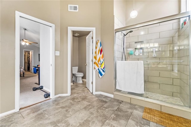 full bathroom with visible vents, a shower stall, baseboards, toilet, and a ceiling fan