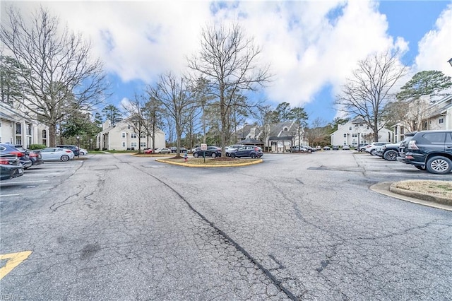 view of road with a residential view and curbs