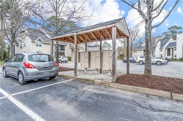 uncovered parking lot with a residential view and mail area