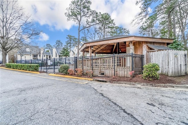 exterior space with a residential view and fence