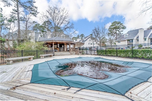 view of pool featuring a fenced in pool, a residential view, a deck, and fence