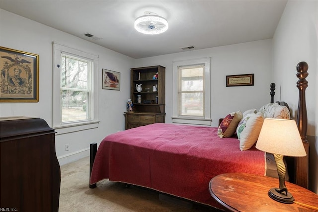 bedroom with visible vents, carpet floors, and multiple windows