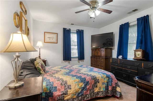 bedroom with carpet flooring, visible vents, and ceiling fan