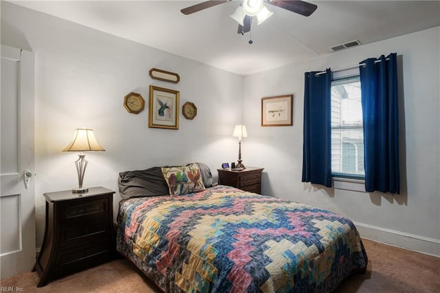 carpeted bedroom with a ceiling fan, baseboards, and visible vents