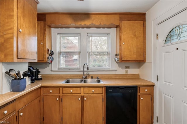 kitchen with brown cabinets, dishwasher, light countertops, and a sink