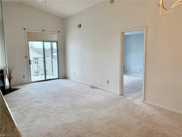 unfurnished room featuring visible vents, baseboards, lofted ceiling, carpet floors, and a textured ceiling