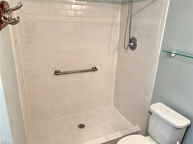 bathroom with a shower stall and toilet