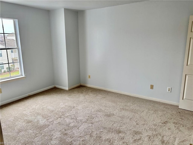 unfurnished room with baseboards and carpet floors