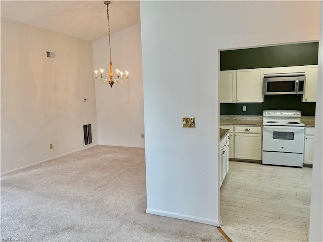 kitchen with visible vents, an inviting chandelier, white cabinetry, stainless steel microwave, and white range with electric stovetop