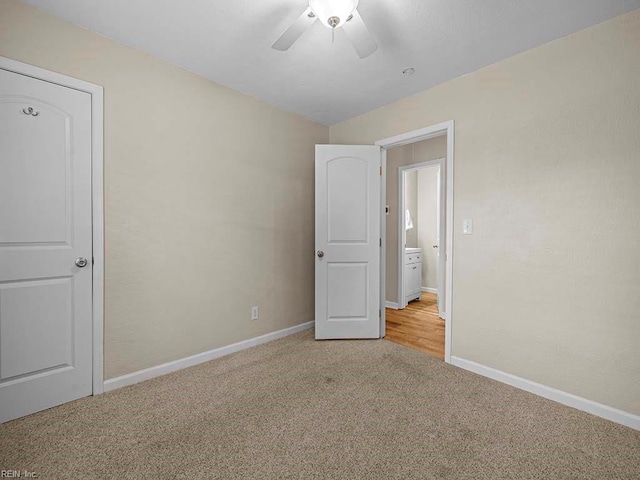 unfurnished bedroom with light colored carpet, baseboards, and ceiling fan