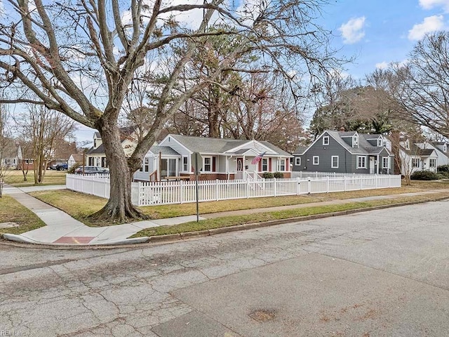 view of front facade featuring a fenced front yard and a residential view